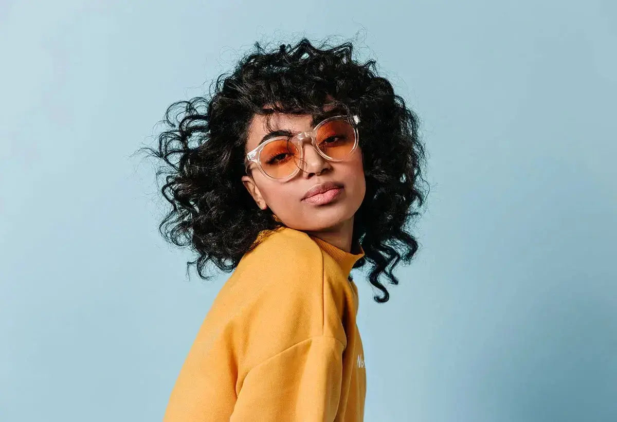 Woman wearing beautiful cat eye glasses with orange lenses, trendy eyewear fashion