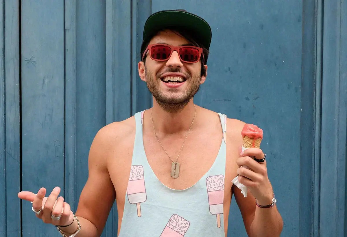 Man wearing beautiful cat eye glasses in red color, smiling with ice cream cone
